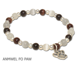 Animal Welfare bracelet by A Different Twist with black, white, brown and gray fiber optic beads with a sterling silver Paw charm and spacer beads on jeweler’s elastic available in three sizes.