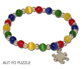 Autism Awareness bracelet by A Different Twist with blue, green, yellow and red fiber optic beads with a sterling silver Puzzle charm and spacer beads on jeweler’s elastic available in three sizes.